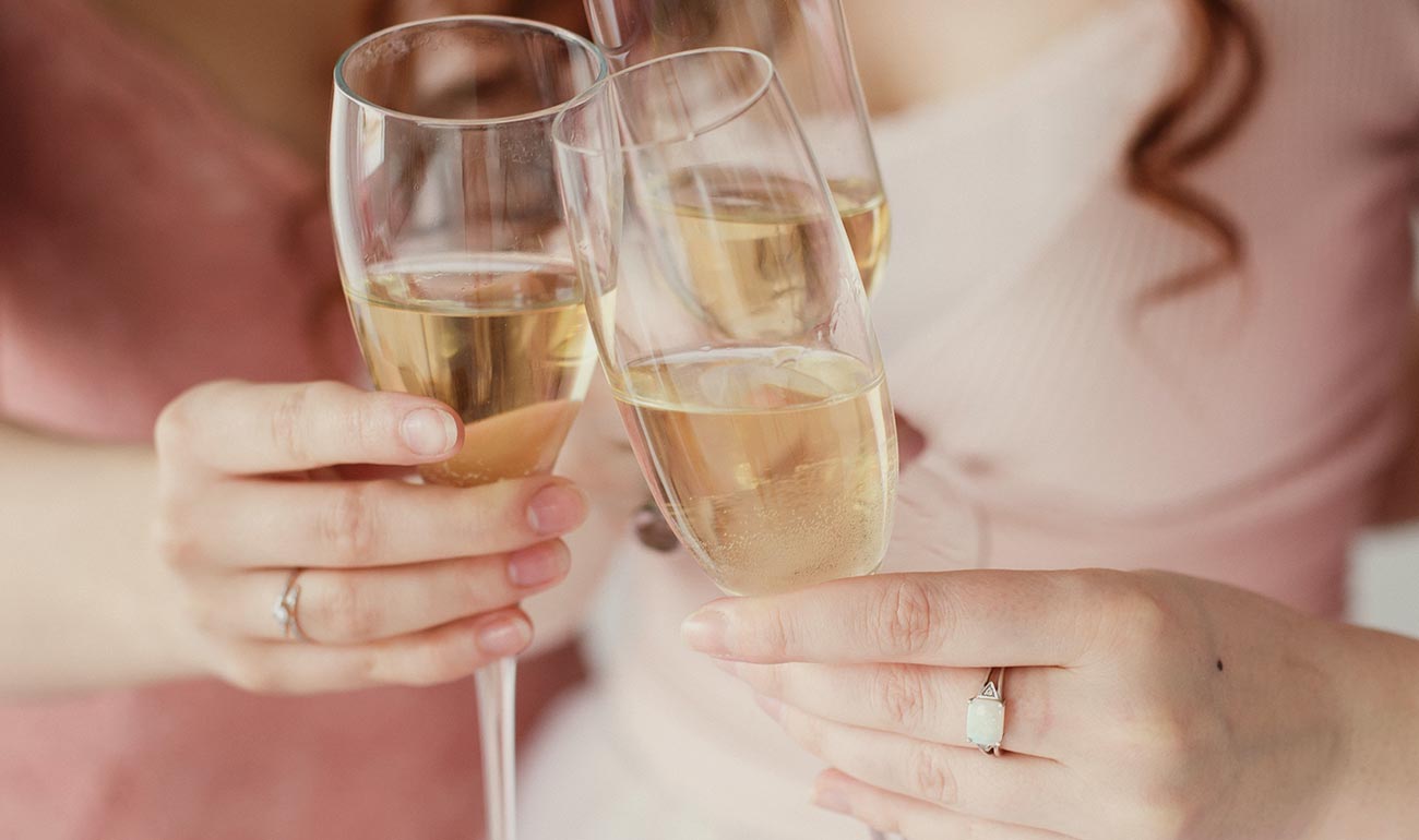 A place setting with a croissant and orange juice.
